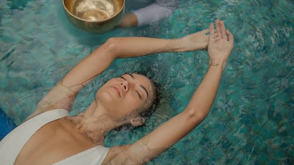 Woman floating peacefully during an aquatic bodywork session